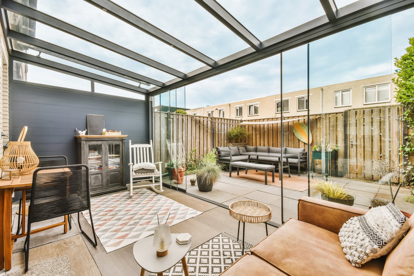 Glass veranda enclosing a contemporary patio seating area
