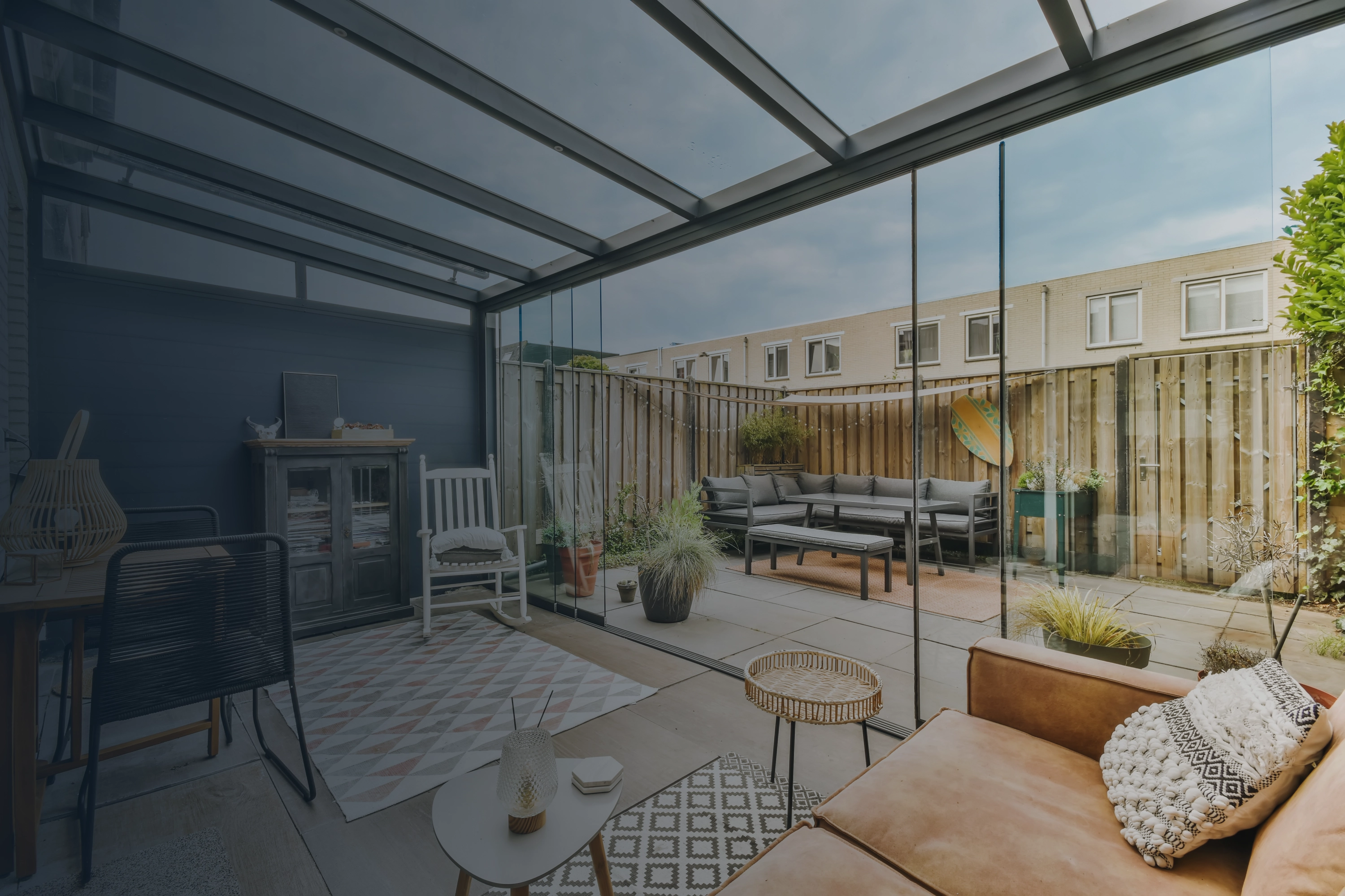 Covered patio and glass outdoor living space by Evolve Outdoors