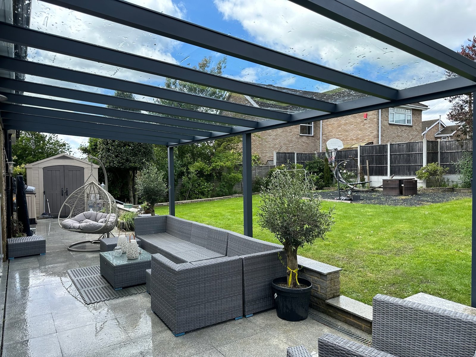 Anthracite grey glass roof veranda over garden seating